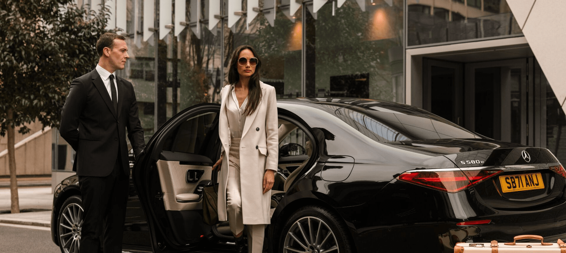 Professional Comfy Ride chauffeur beside executive private hire vehicle